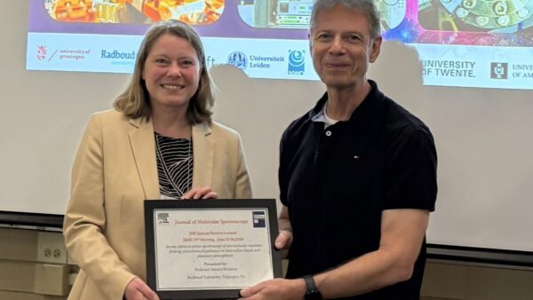 A picture of JMS editor Michael Heaven presenting the award to Prof. Sandra Brünken.